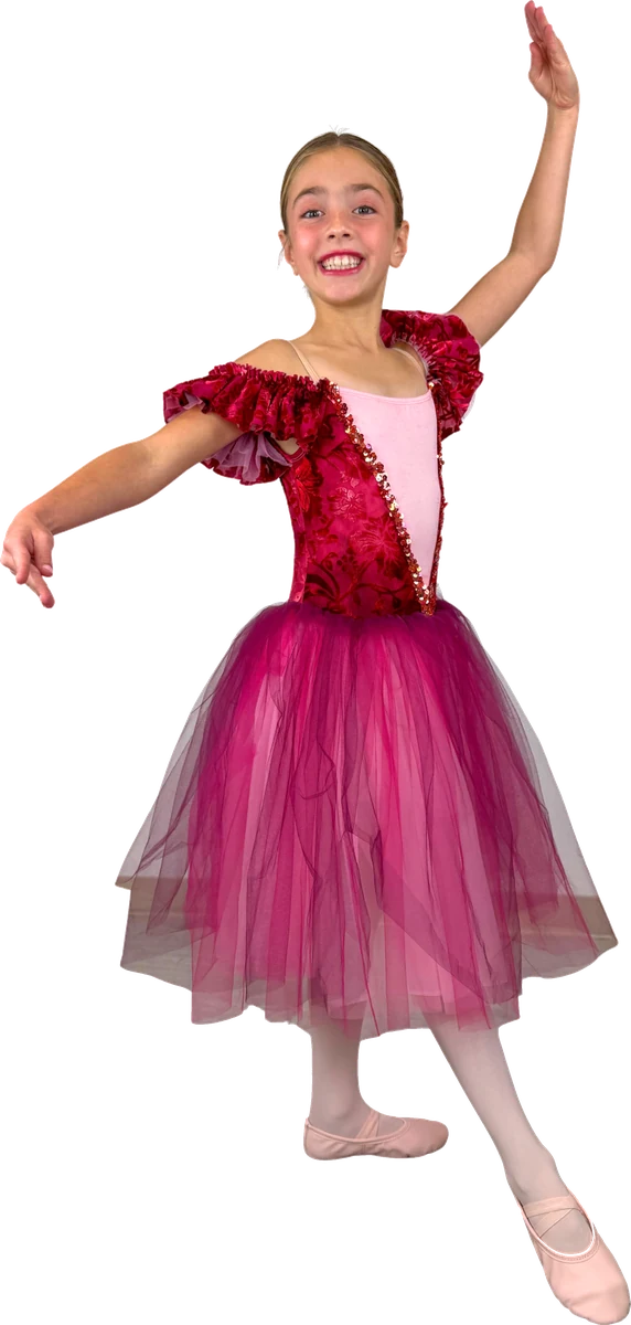 Junior dancer in a red and pink tutu with one arm raised